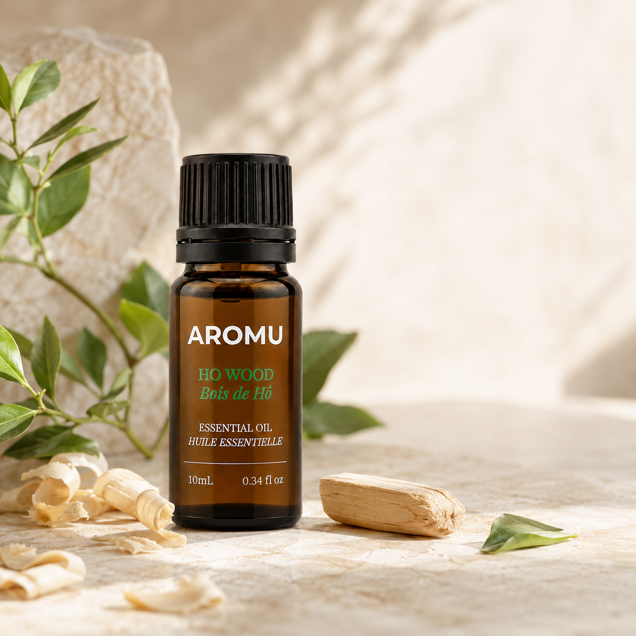 Ho Wood Essential Oil with natural wood and green leaves