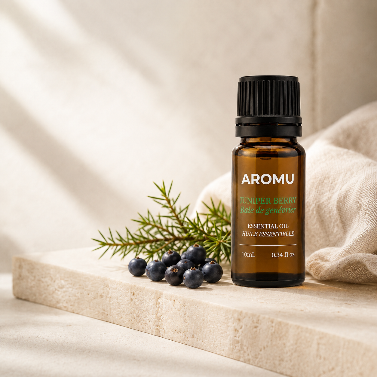 AROMU Juniper Berry Essential Oil in warm natural light