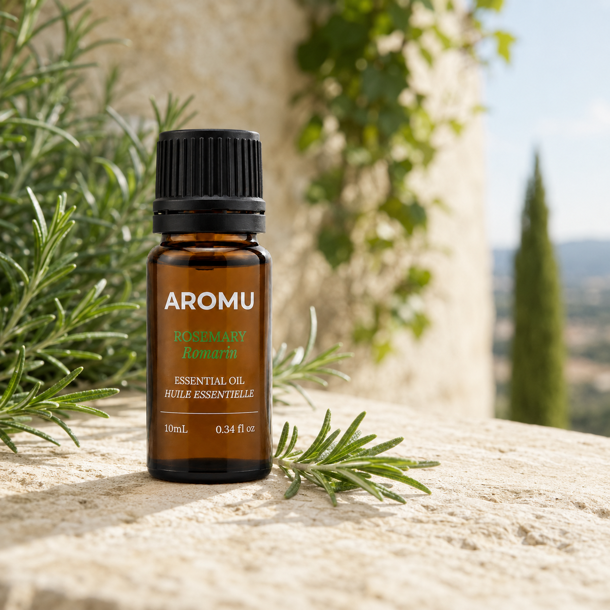 AROMU Rosemary Essential Oil with fresh rosemary in a Mediterranean setting