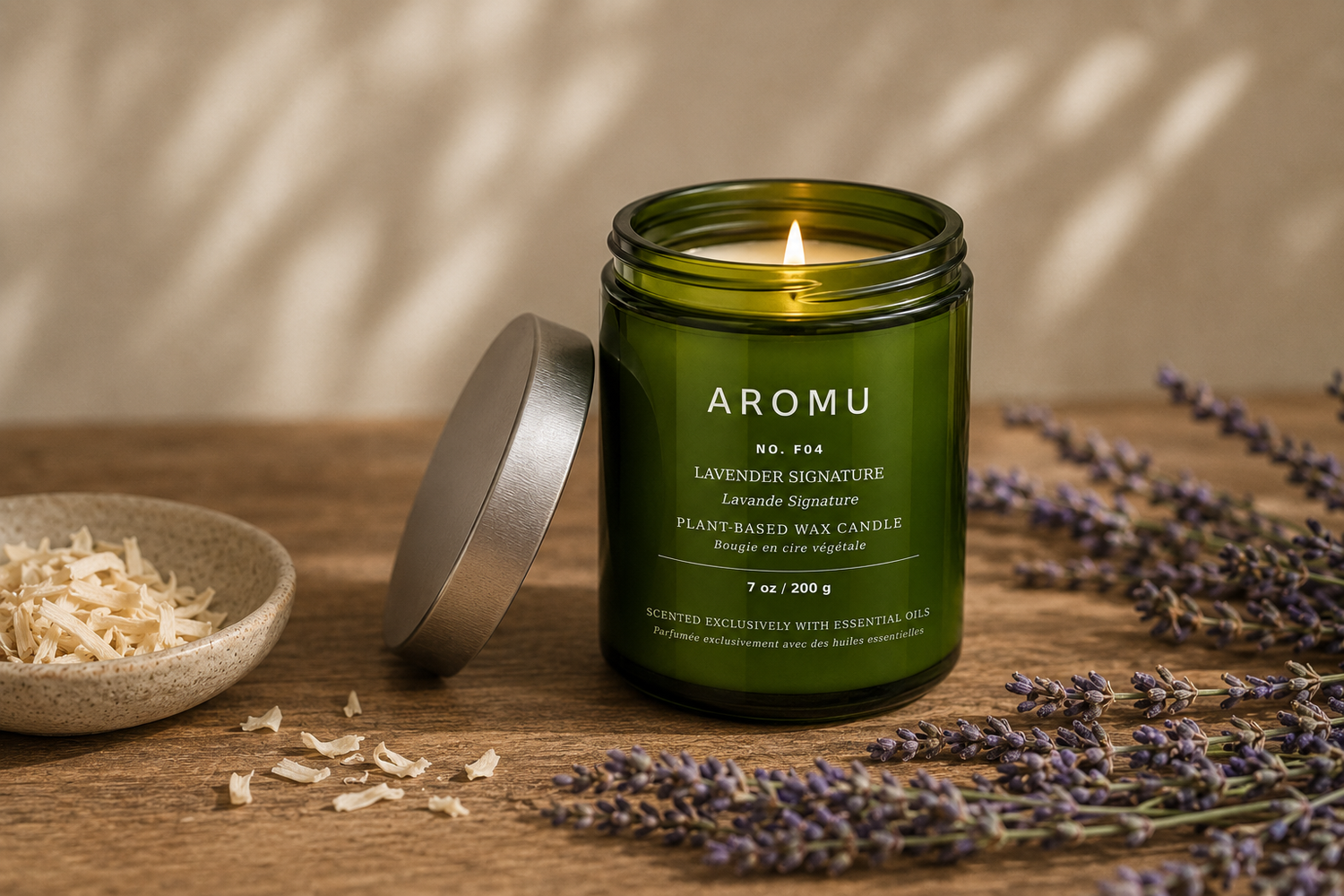 Lavender Signature essential oil candle burning with lavender and pale wood botanicals