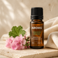AROMU Geranium Essential Oil with pink geranium flowers