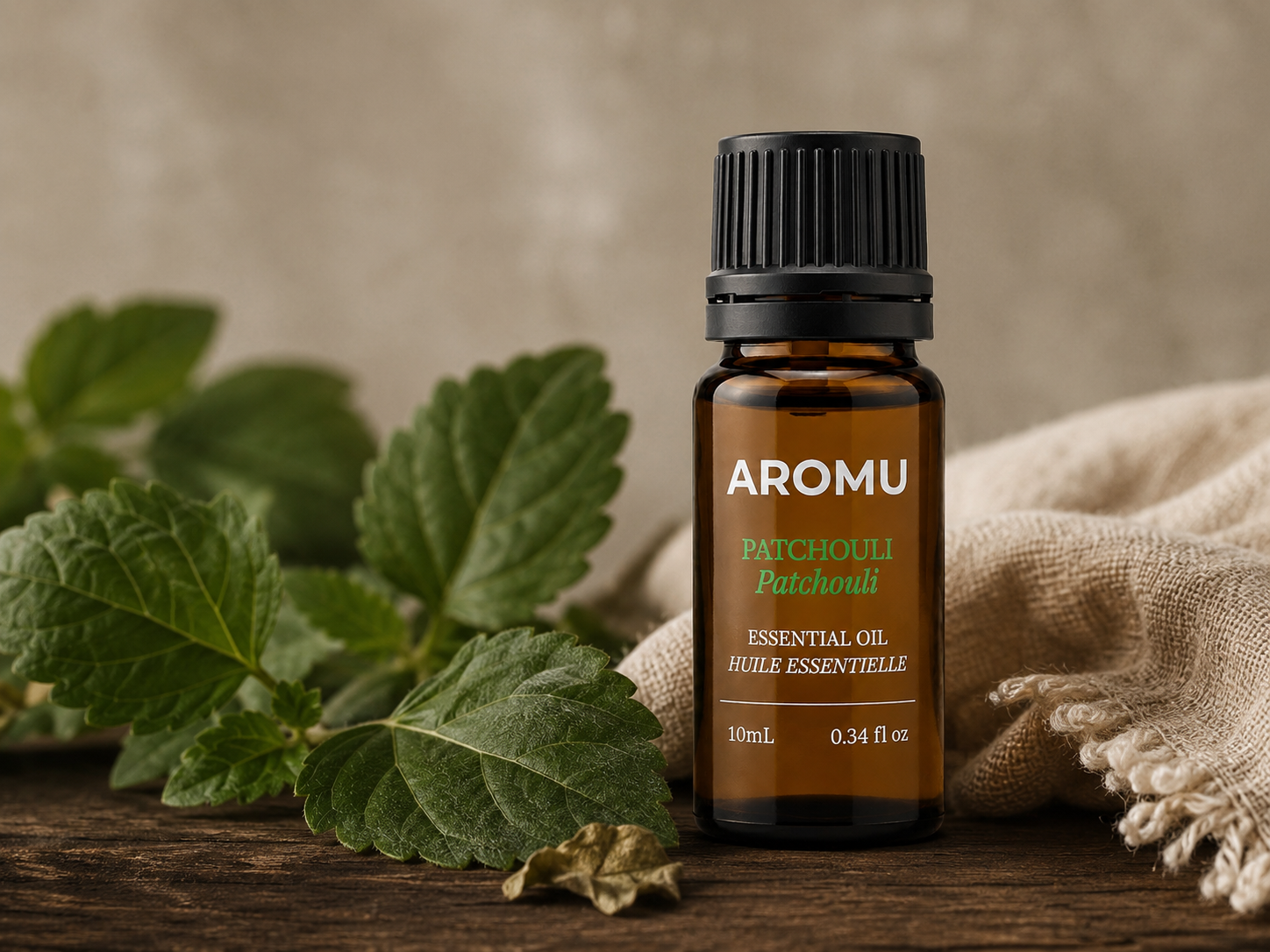AROMU Patchouli Essential Oil with green leaves and natural linen