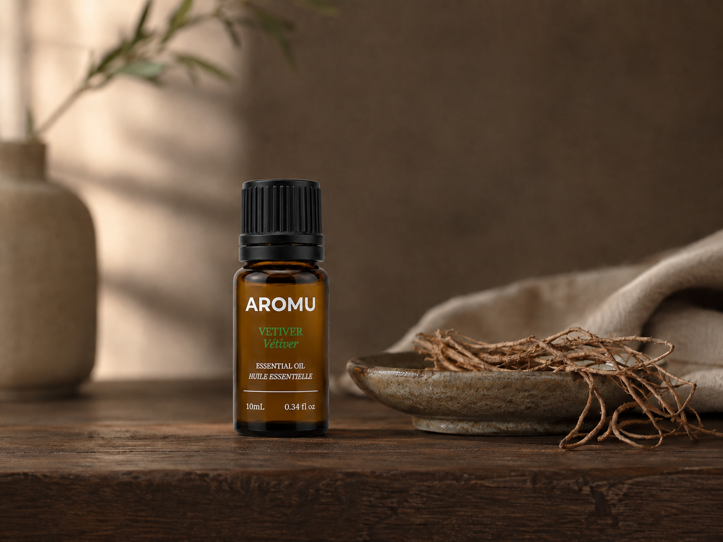 AROMU Vetiver Essential Oil in a grounded botanical setting